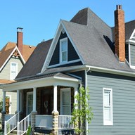 Roofer locking a standing-seam panel